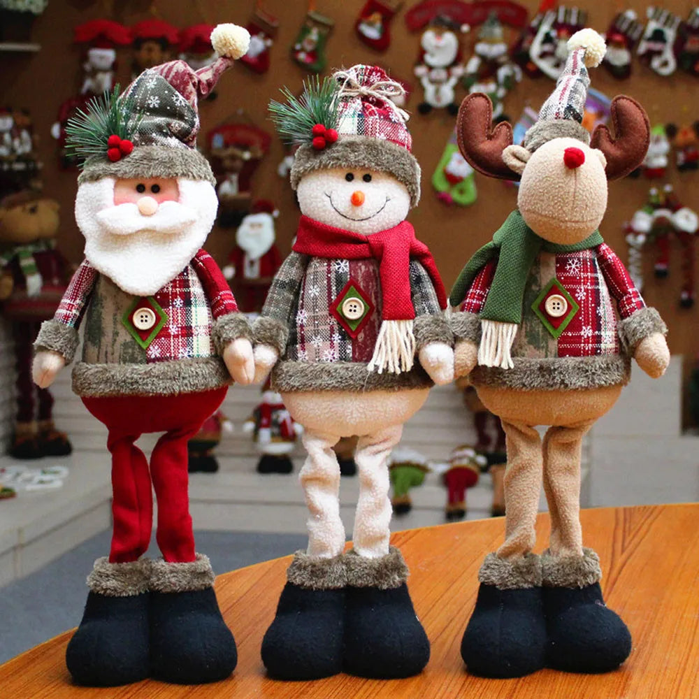 Three Christmas-themed figurines on a wooden surface with a festive background.